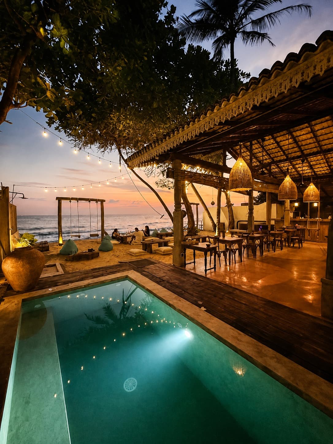 Private beachfront dinner setup with ocean view